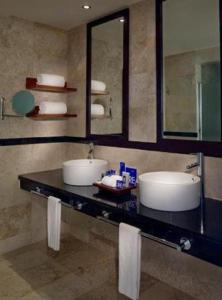 a bathroom with two sinks and a mirror at Grand Sunset Princess - All Inclusive in Playa del Carmen