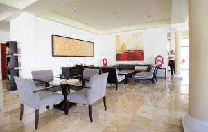sala de estar con mesa de comedor y sillas en Grand Sunset Princess - All Inclusive en Playa del Carmen