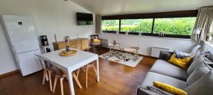 a living room with a couch and a table at Manou du Lac Annecy in Doussard