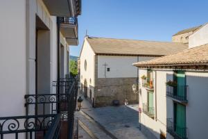 an alley between two buildings with a person walking on the street at OTAL URBAN de "Casa Otal" in Jaca
