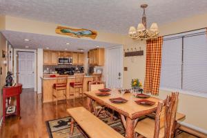 a dining room and kitchen with a table and chairs at Happy Trails, Hot Tub, In Pigeon Forge Near Strip, Hot Tub, WIFI!!! in Pigeon Forge