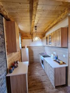 une cuisine avec des armoires en bois et un réfrigérateur dans l'établissement Original Wooden Lodge 2, à Žabljak