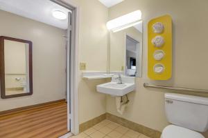 a bathroom with a sink and a toilet and a mirror at Motel 6-Raleigh, NC - North in Raleigh +34 photos