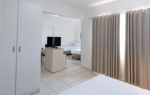 Cama ou camas em um quarto em Best Western Suites Le Jardin Caldas Novas