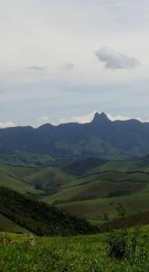 a view of a green valley with mountains in the background at Gran Camping Cabanas da Fazenda in Visconde De Maua
