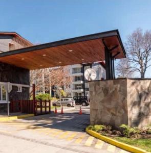 a building with a roof with a clock on it at Departamento en Pucón in Pucón