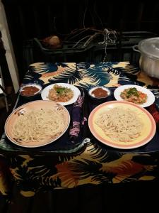 a table topped with plates of pasta and sauce at ROYAL Tapo-Tapo in Patio