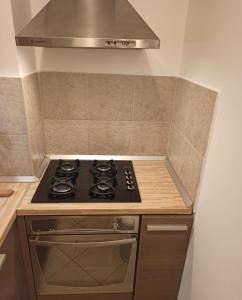 a kitchen with a stove and a hood at Zagreb LAKE STAR & Included garage parking place in Zagreb