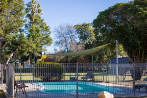 a swimming pool with a tent and a fence at Gardenview in Wangaratta