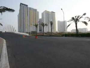 an empty street in a city with tall buildings at Apartemen Springlake Summarecon Bekasi-By Bu Johan in Bekasi