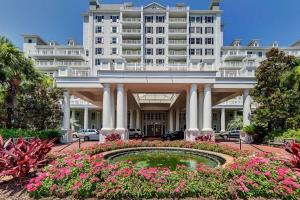 a hotel with a fountain in front of a building at The Grand Sandestin in Destin