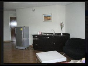 a living room with a couch and a refrigerator at Room in Studio - T8 Guest House Don Mueang Challenger triple room in Ban Song Hong