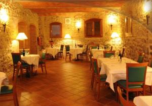 a dining room with white tables and chairs in a building at Hotel La Spia D'Italia in Solferino