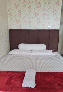 a bed with two white pillows on top of it at Apartemen Springlake Summarecon Bekasi-By Bu Johan in Bekasi