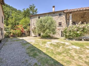 an external view of a stone house with a yard at Belvilla by Oyo San Godenzo Casa Grande 2 in San Godenzo