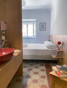 een slaapkamer met een bed en een badkamer met een wastafel bij Sognalibro Bed and Books in Ragusa