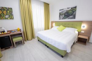 a bedroom with a bed and a desk with a television at Casa Marino in Sorrento