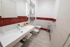 a bathroom with a white sink and a toilet at Casa Marino in Sorrento