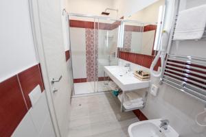 a bathroom with a toilet and a sink and a shower at Casa Marino in Sorrento
