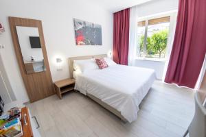 a small bedroom with a bed and a window at Casa Marino in Sorrento