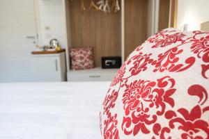 a red and white pillow on a bed in a room at Casa Marino in Sorrento