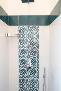 a bathroom with a shower with a tiled wall at Casa Marino in Sorrento