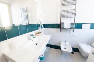 a bathroom with a sink and a toilet and a mirror at Casa Marino in Sorrento