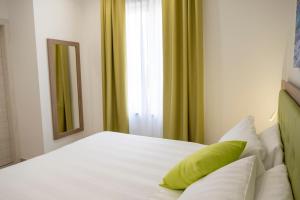 a bedroom with a white bed and a window at Casa Marino in Sorrento