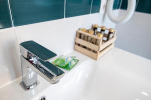 a bathroom sink with a soap dispenser on it at Casa Marino in Sorrento