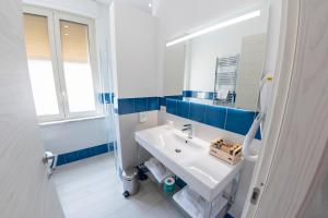 a bathroom with a white sink and a mirror at Casa Marino in Sorrento