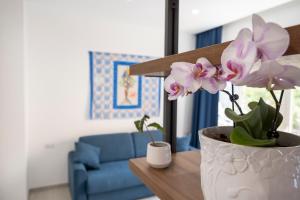 a vase with flowers on a table in a living room at Casa Marino in Sorrento