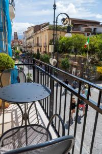 a table and chairs on a balcony with a street at Casa Marino in Sorrento