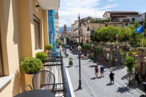 a city street with people walking down the street at Casa Marino in Sorrento