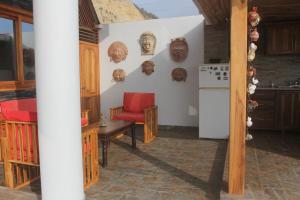 eine Küche mit einem roten Stuhl und einem Kühlschrank in der Unterkunft El Ocaso in Canoa