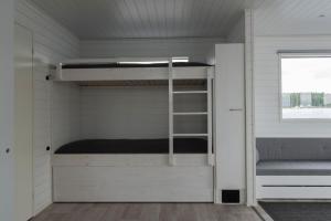 a room with a bunk bed and a window at Saunalautta Sisu in Imatra