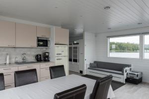 a kitchen with a table and chairs and a couch at Saunalautta Sisu in Imatra