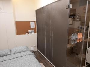 1 dormitorio con ducha de cristal y 1 cama en 光鹿旅人短期月租出租 en Tanzi
