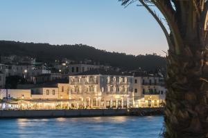 a group of white buildings next to a body of water at Klimis Hotel in Spetses
