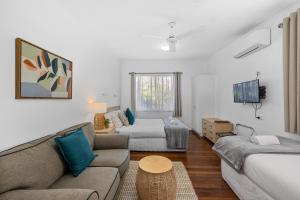 a living room with a couch and a table at Ocean Park Motel & Holiday Apartments in Coffs Harbour