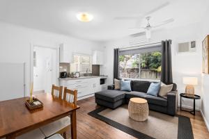 a living room with a couch and a table at Ocean Park Motel & Holiday Apartments in Coffs Harbour