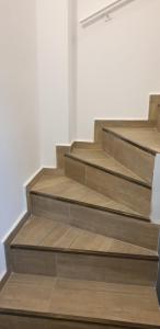 a set of wooden stairs in a room at Cattleya's Loft in Veliko Tŭrnovo