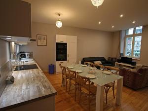 a kitchen and living room with a table and chairs at Gîte Épinal, 4 pièces, 6 personnes - FR-1-589-82 in Épinal