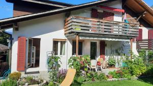 a house with a balcony on top of it at Berner Oberland Am Thunersee in Därligen +16 photos