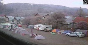 a group of tents and cars parked in a parking lot at Camping Aviator Busteni, Parcela campare Corturi in Buşteni