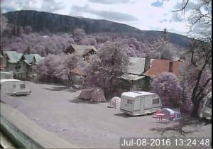 a group of tents and a trailer in a parking lot at Camping Aviator Busteni, Parcela campare Corturi in Buşteni +4 photos