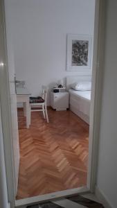 a room with a desk and a bed and a table at Apartman PARK in Trebinje