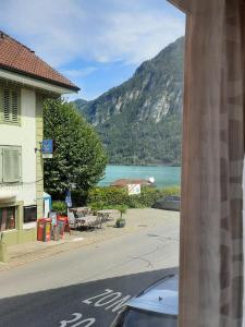 a view of a street and a lake from a building at Berner Oberland Am Thunersee in Därligen