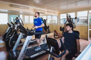 Twee mannen in de sportschool op loopbanden. bij Mirita Hotel ,10th Of Ramadan in Madinat Al Ashir min Ramadan