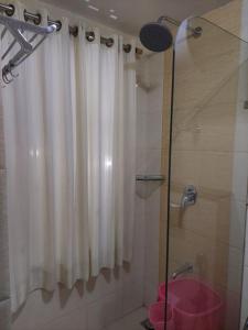a bathroom with a shower with a shower curtain at Hotel Grand Habib in Srinagar +33 photos