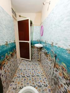 een badkamer met een douche, een wastafel en een toilet bij hari Darshan in Orchha